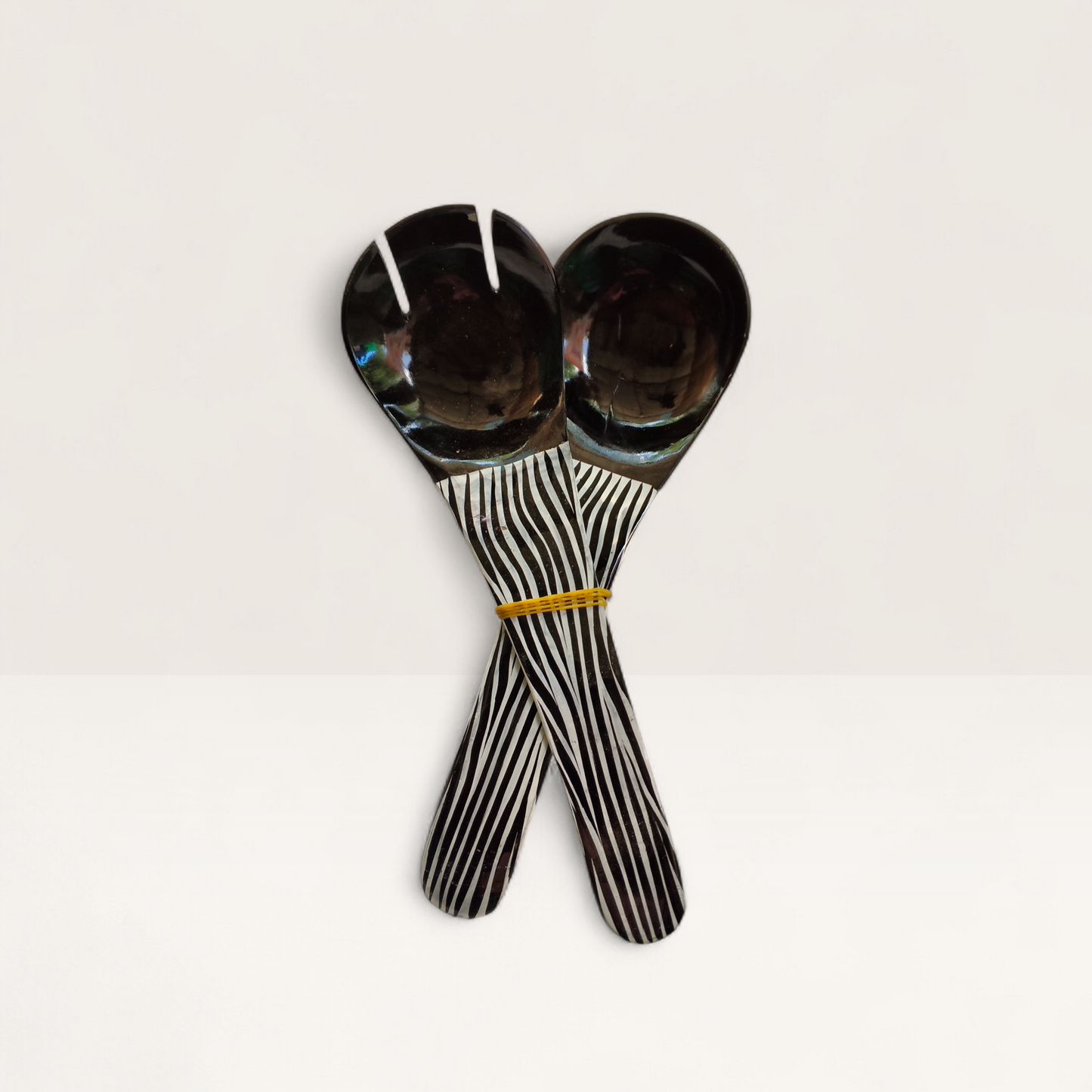 Handcrafted 2-piece set of Kenyan cow horn salad servers with black horn heads and zebra stripe batik handles, made in Kenya.