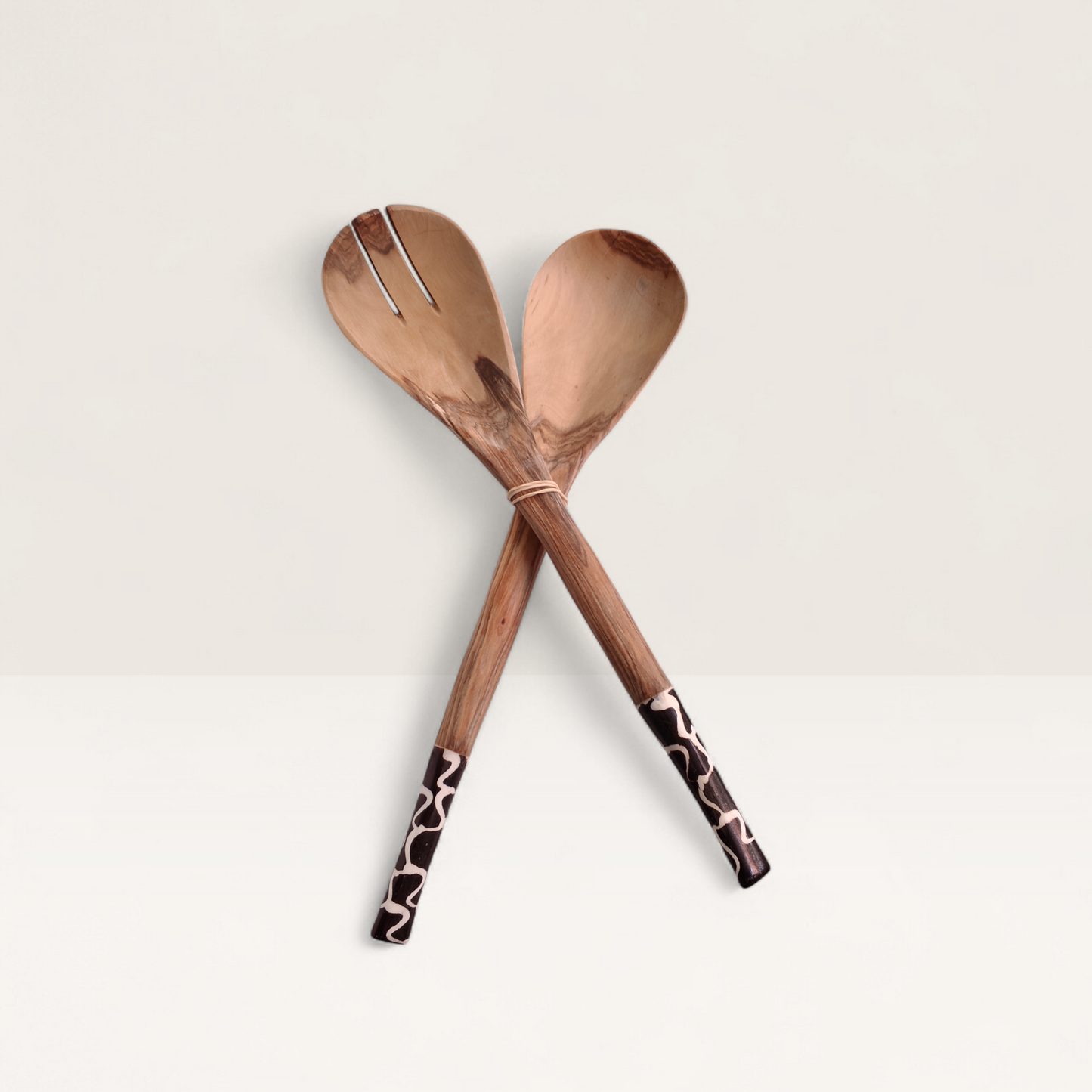 Set of 2 handcrafted Kenyan olive wood serving spoons with black and white batik bone handles.