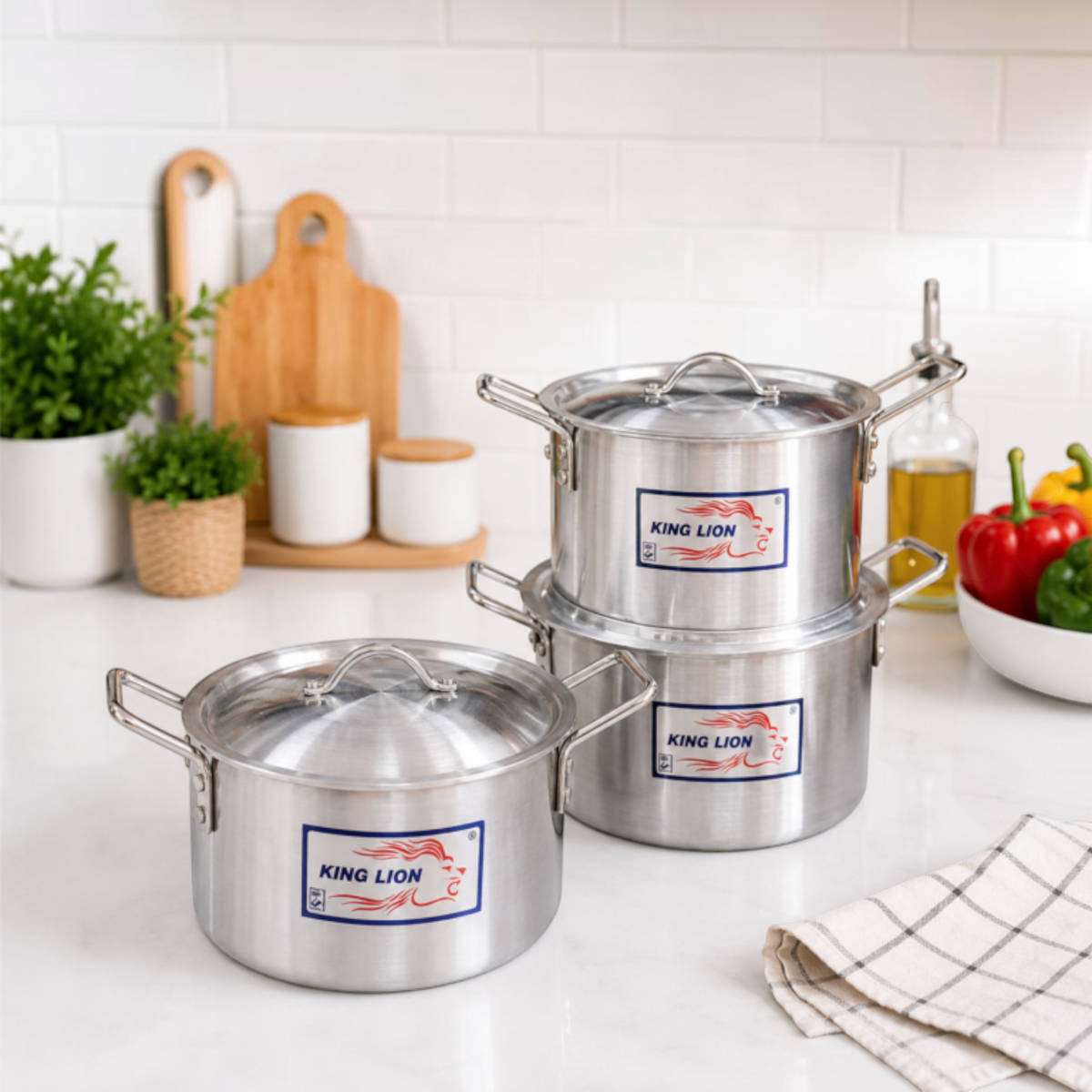 King Lion 3 piece chrome hi casserole aluminium sufuria set 5L 7L 9L with lids manufactured by Kaluworks displayed on a white kitchen counter