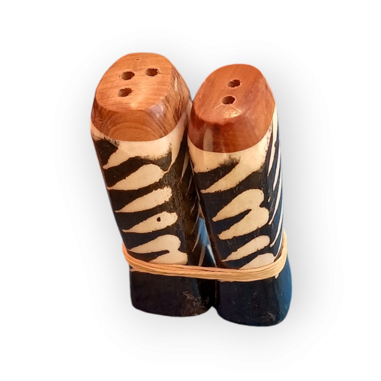 Kenyan handcrafted cow bone salt and pepper shakers set with unique zebra-inspired design.