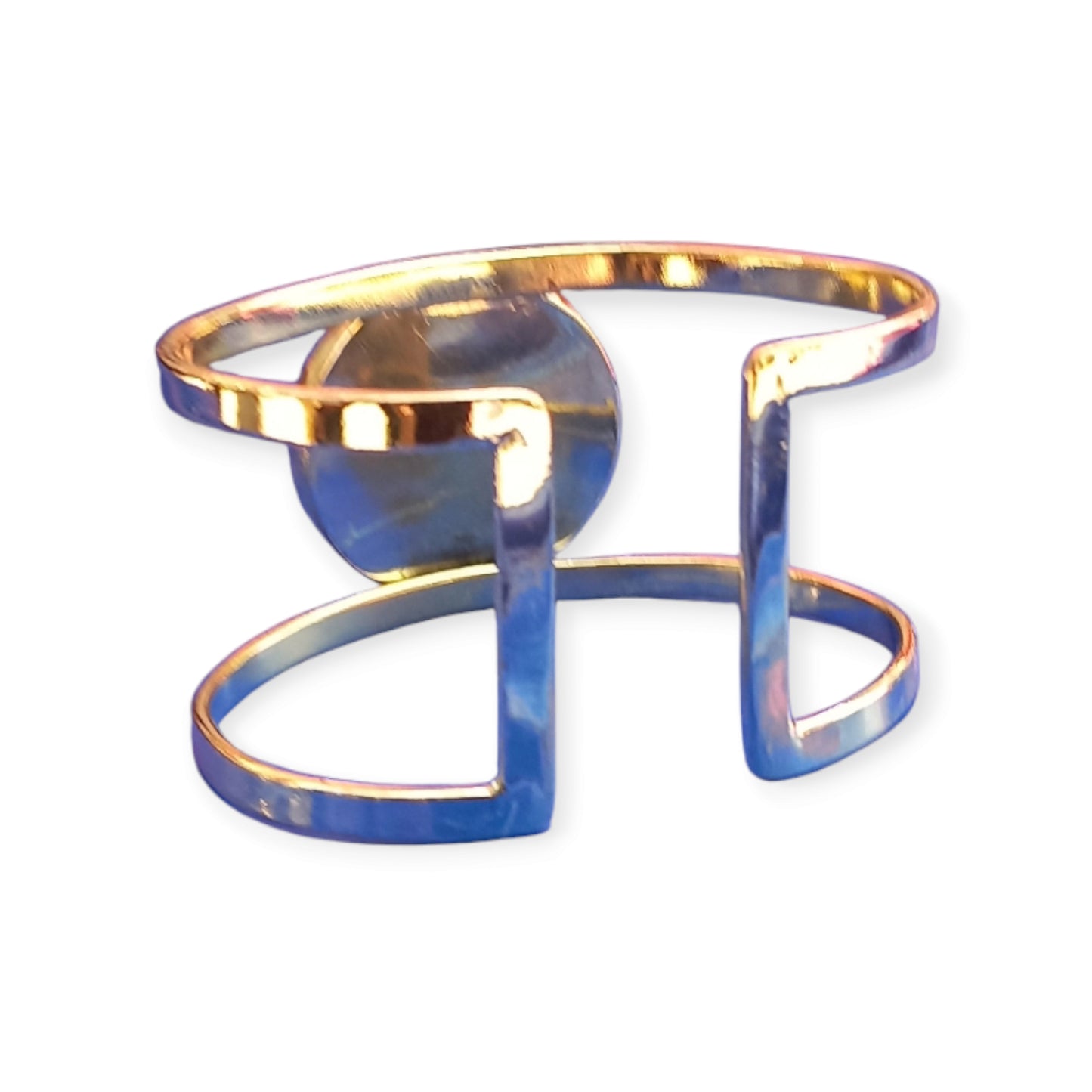 Handcrafted Kenyan brass wide cuff bracelet with a prominent cherry red colored stone at its center.