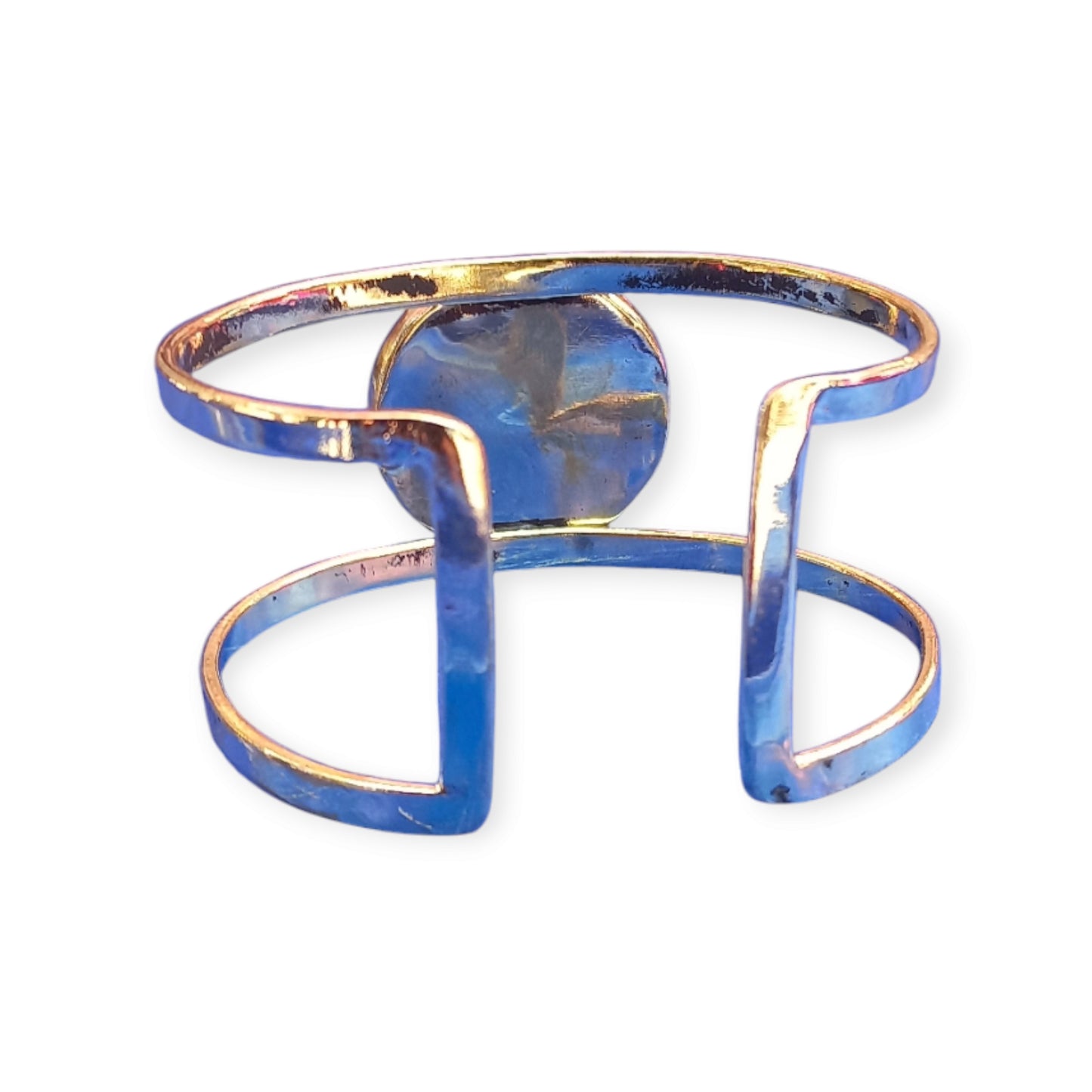 A handcrafted, adjustable brass bracelet from Kenya, designed as a double open cuff and featuring a striking, large emerald green amber ornament.
