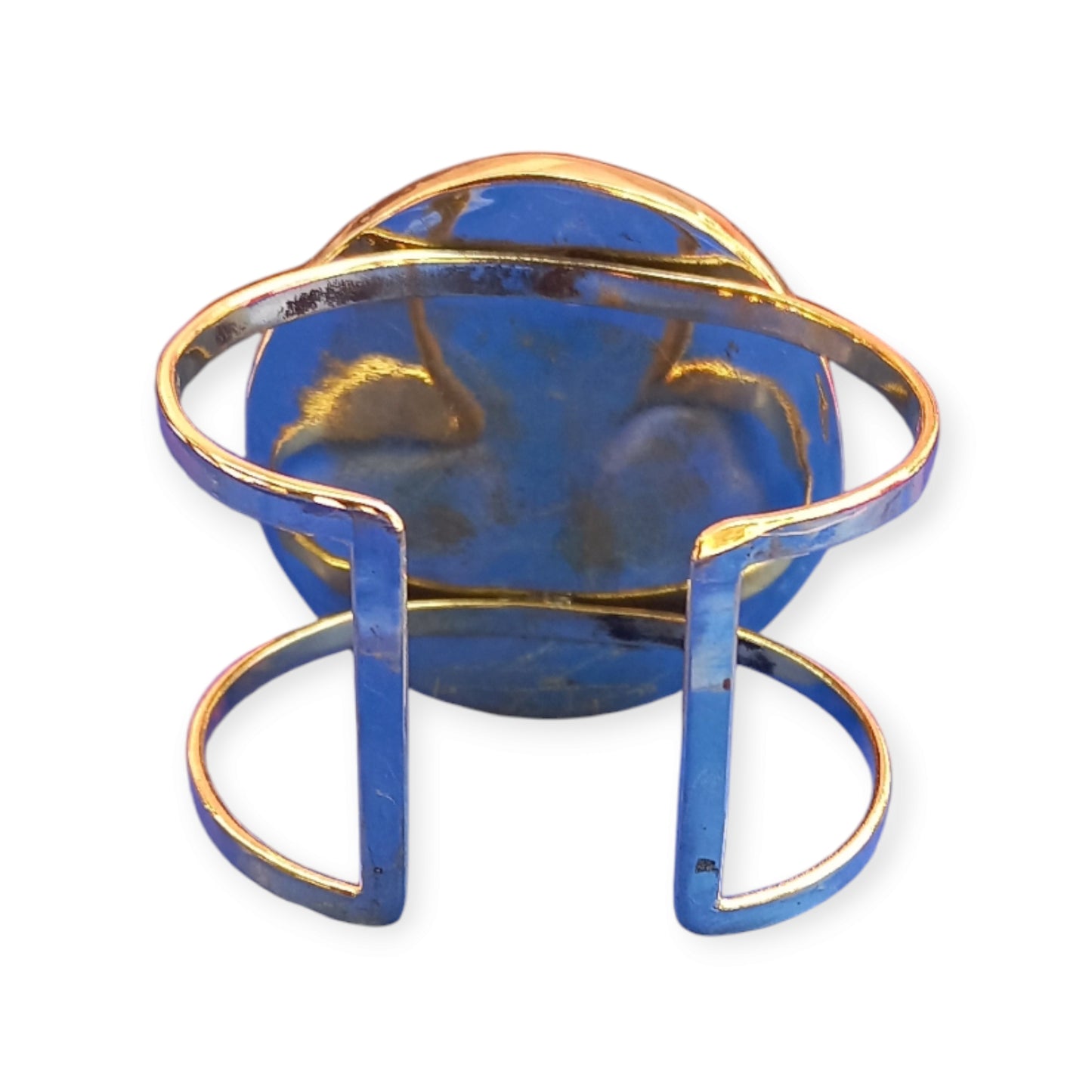 Handcrafted Kenyan brass wide cuff bracelet with a prominent circular Maasai beadwork design.