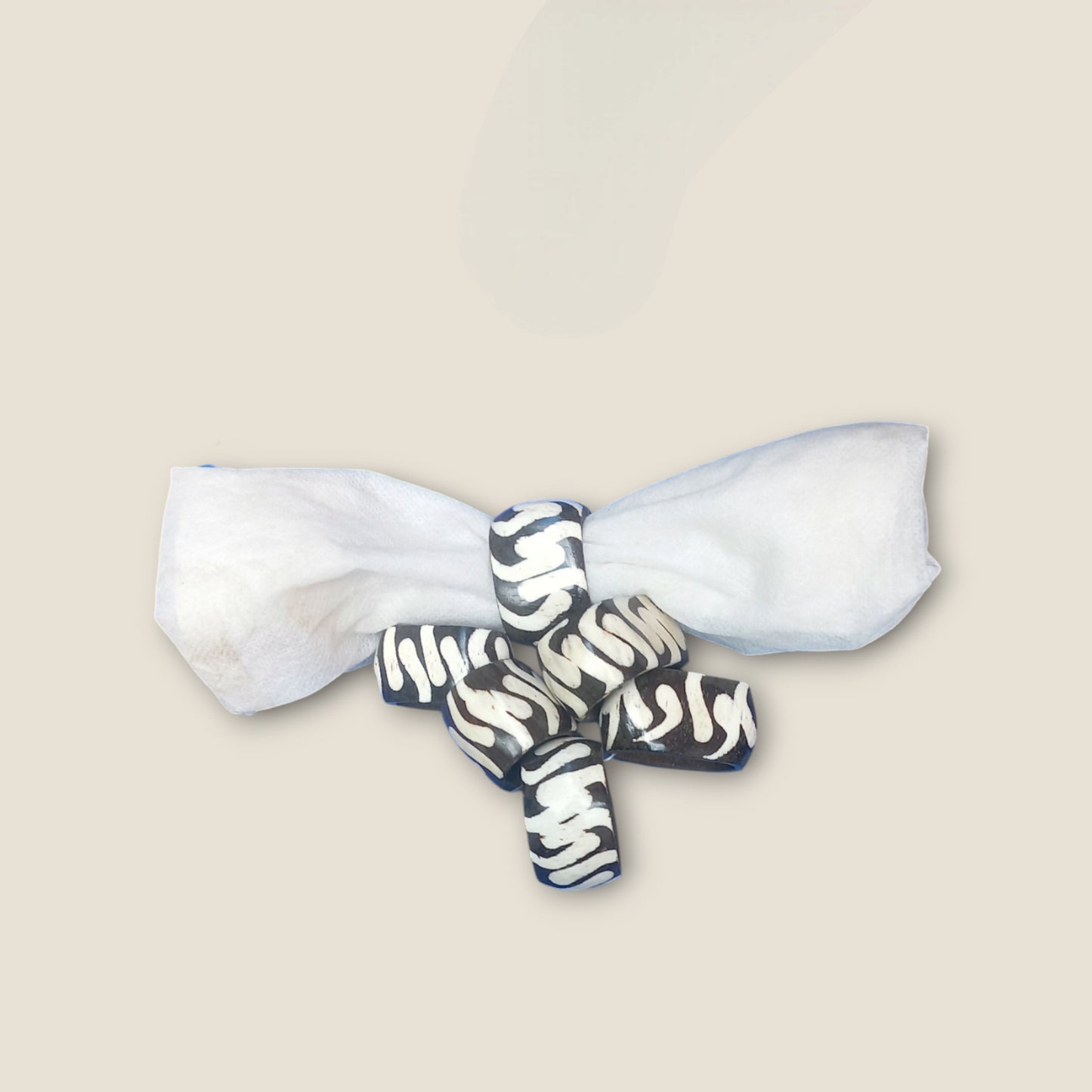 Kenyan handcrafted bone napkin rings set of 6 with unique wavy pattern.