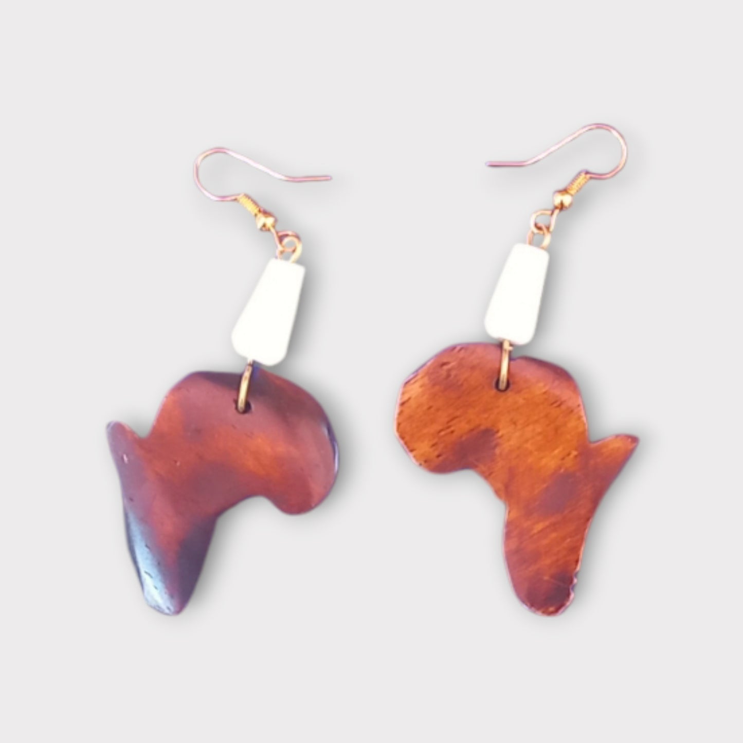 Dangle earrings with a detailed Africa map pendant made of ethically sourced bone, crafted in Kenya.