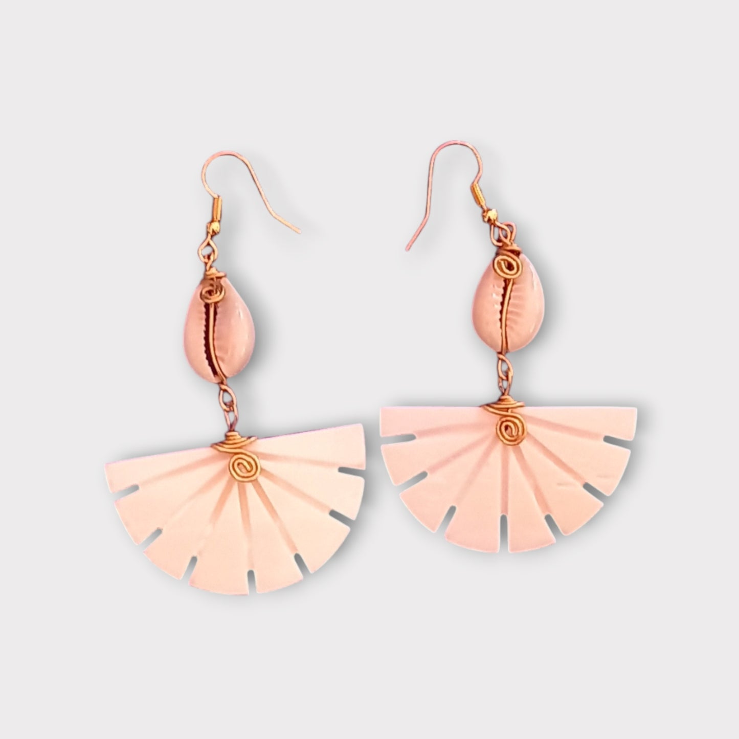 Handcrafted Kenyan earrings featuring a white cowrie shell and a unique, fan-shaped bone pendant with radiating slots.