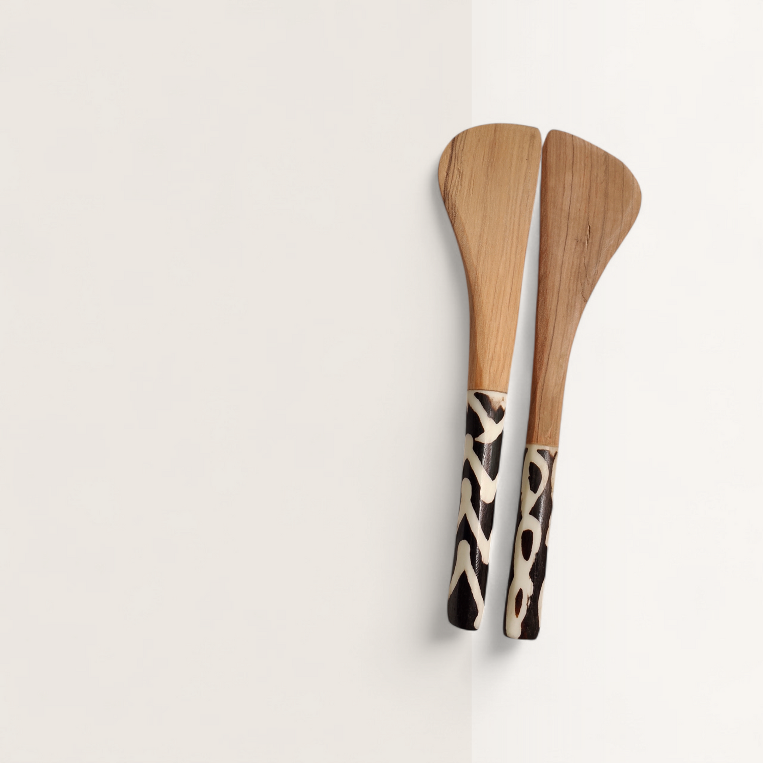Handcrafted set of 2 Kenyan olive wood butter spreader knives with batik bone inlaid handles, made in Ukambani Kenya.
