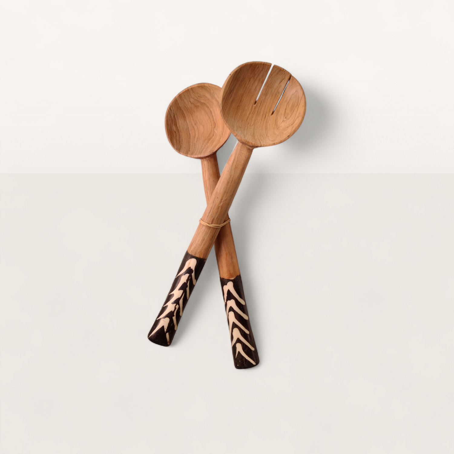 Handcrafted 2-piece Kenyan olive wood salad serving spoons with dark chevron batik bone handles, made in Ukambani Kenya.
