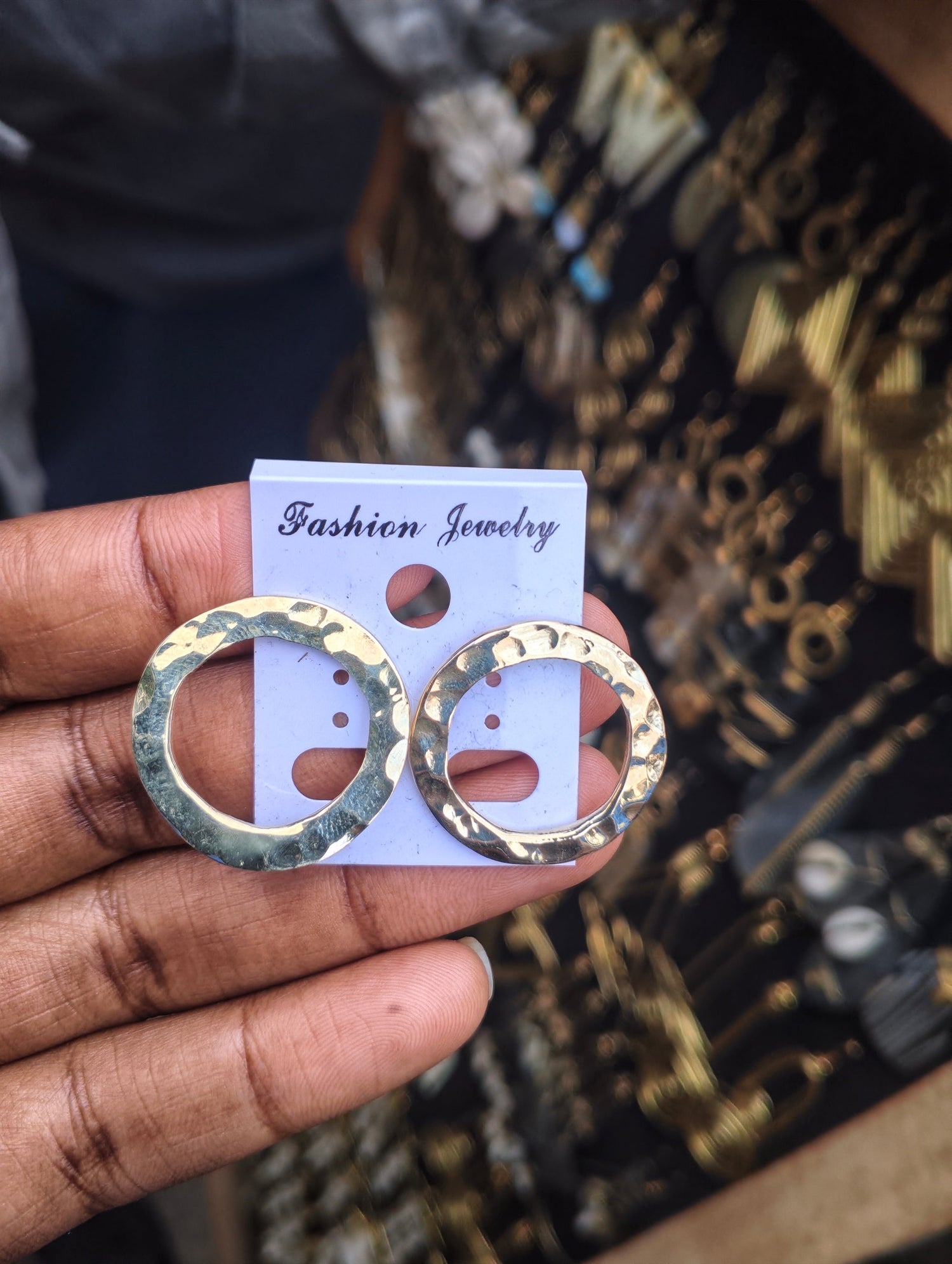 Handcrafted open circle brass hoop earrings with textured hammered finish, artisan made in Kibera Nairobi Kenya