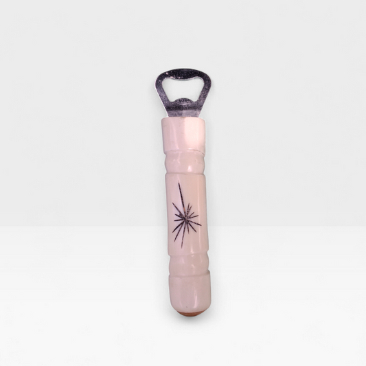 Handcrafted starburst cow bone bottle opener with hand etched sunburst engraving made by Kibera artisans in Kenya