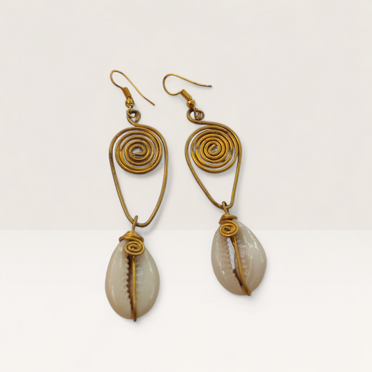 Handcrafted Kenyan drop earrings featuring gold-toned brass spirals and natural white cowrie shell pendants on a white background