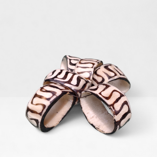 Set of 6 handcrafted Kenyan cow bone napkin rings with brown batik swirl patterns made in Kibera Kenya