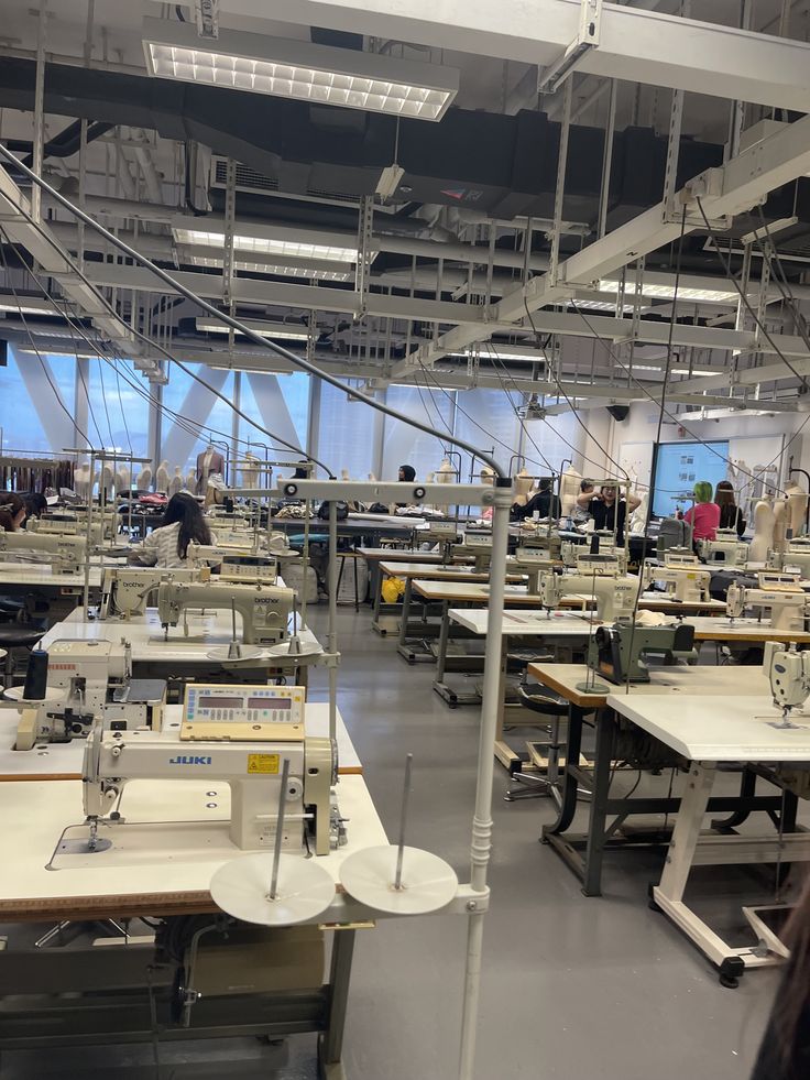 Factory floor with sewing machines and workers in a large industrial setting