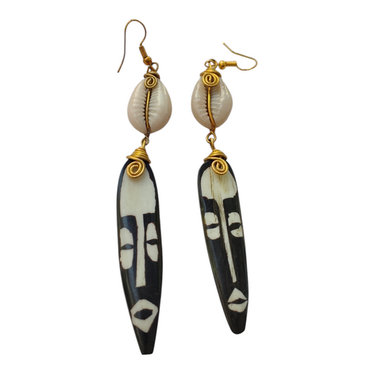 Hand-carved batik upcycled bone African tribal mask drop earrings with brass wire-wrapped natural cowrie shells, made in Kibera, Nairobi, Kenya.