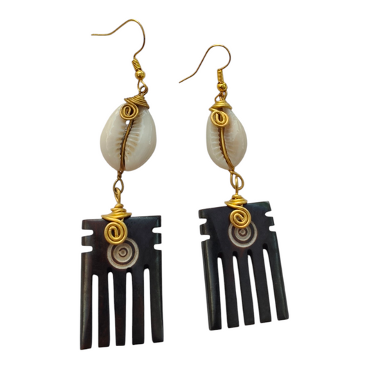 Dark batik-dyed upcycled bone Afro comb earrings with concentric circle pattern and brass wire-wrapped natural cowrie shells, made in Kibera, Nairobi, Kenya.