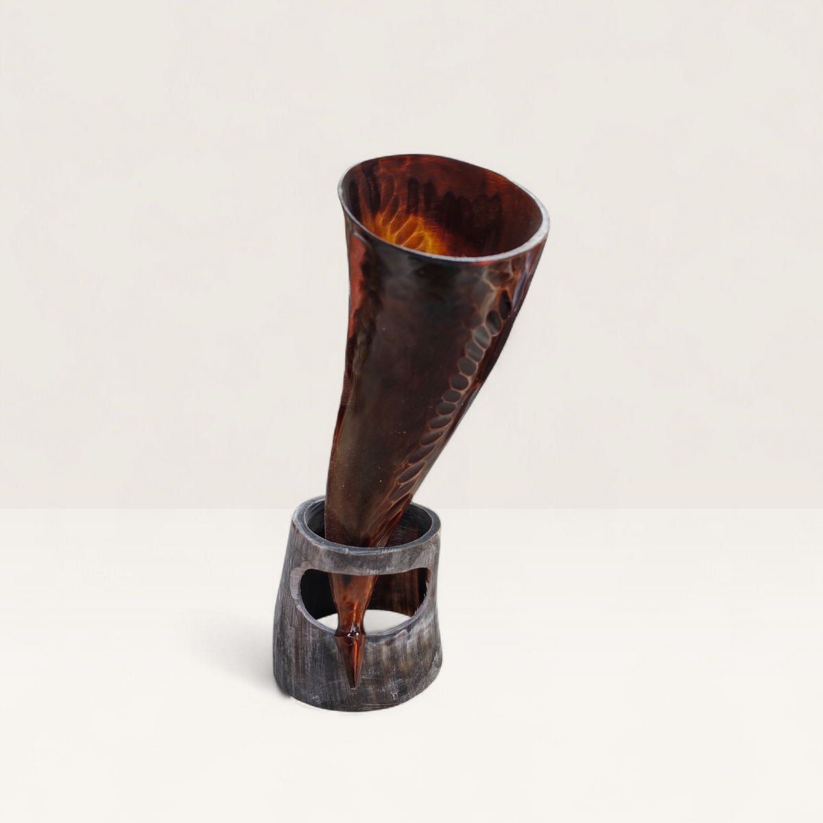 Handcrafted translucent amber and brown hand-carved Kenyan cow horn Muratina drinking horn with a matching dark horn stand, made in Kenya.