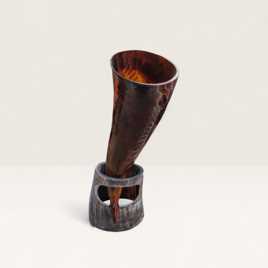 Handcrafted translucent amber and brown hand-carved Kenyan cow horn Muratina drinking horn with a matching dark horn stand, made in Kenya.