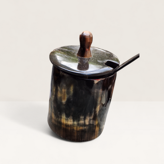 Handcrafted natural dark polished Kenyan cow horn sugar bowl with a dark lid, spoon notch, and horn spoon, made in Kenya.