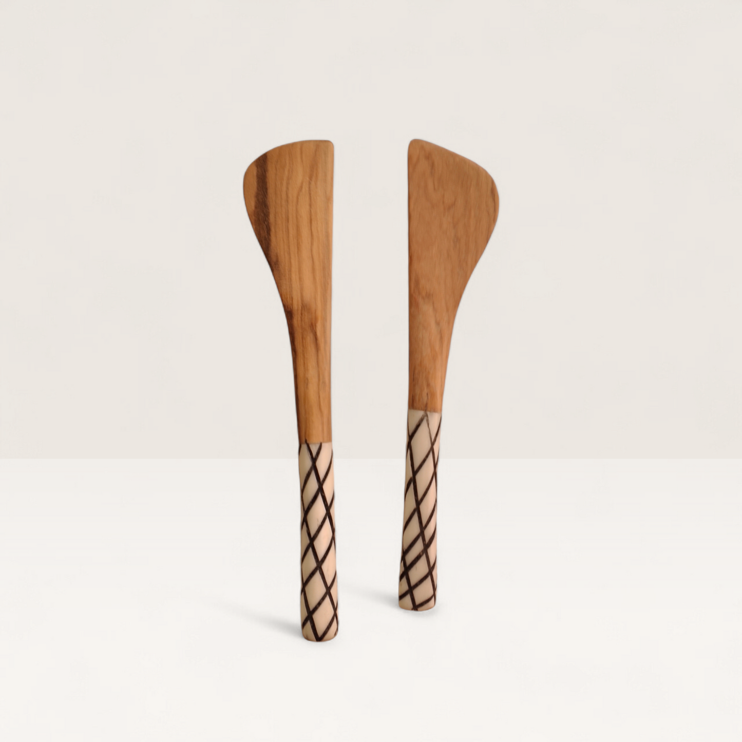Handcrafted set of 2 Kenyan olive wood butter spreader knives with crosshatch lattice bone handles, made in Ukambani Kenya.