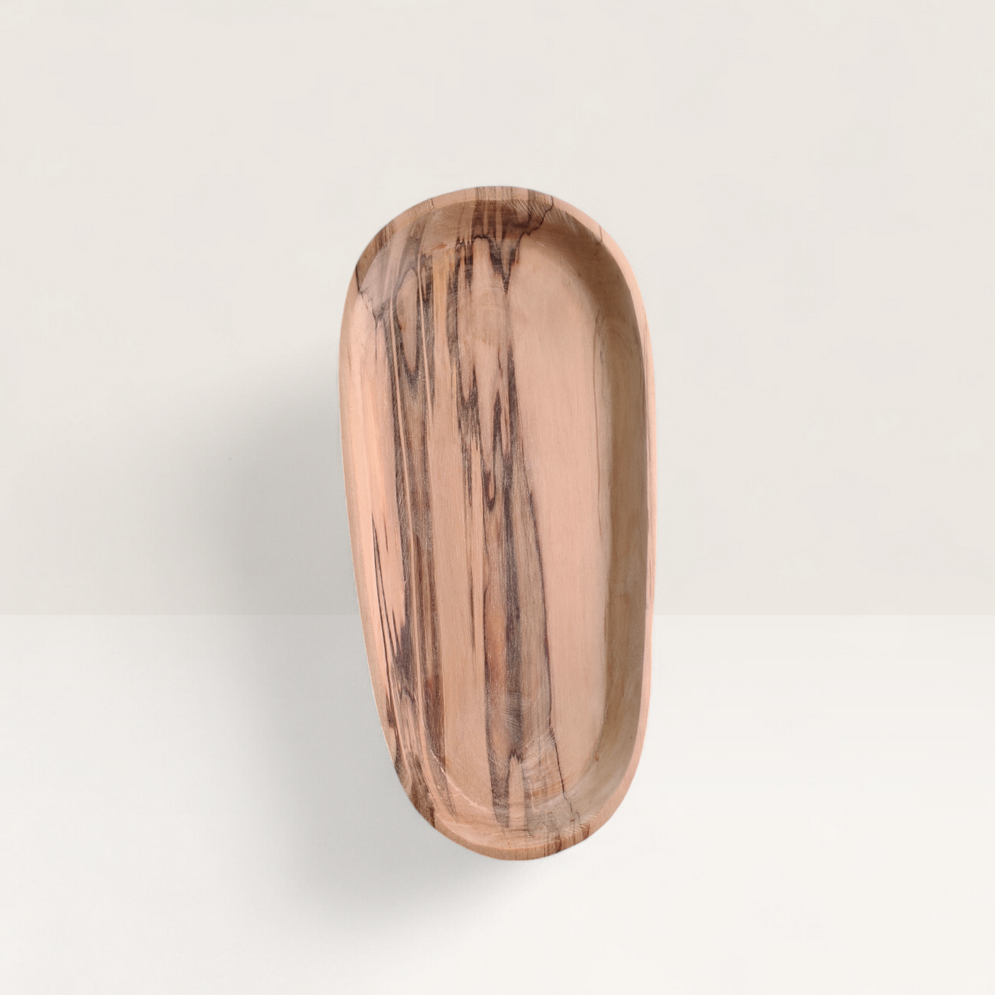 handcrafted oval Kenyan olive wood fish plate and seafood serving dish with dramatic wood grain detail, made in Ukambani Kenya.