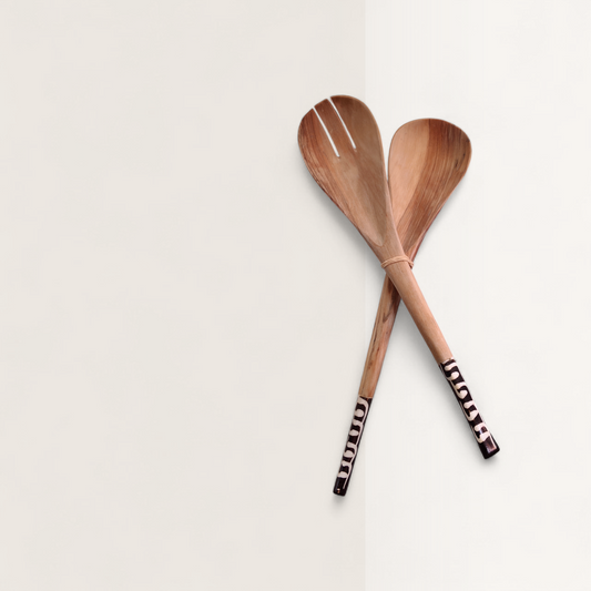 Handcrafted 2-piece set of Kenyan olive wood salad servers with spoon, fork, and zebra batik bone inlaid handles, made in Ukambani Kenya.
