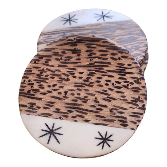 Handcrafted round Kenyan coconut wood coaster set of 4 with starburst batik bone inlay edge, made in Ukambani Kenya.