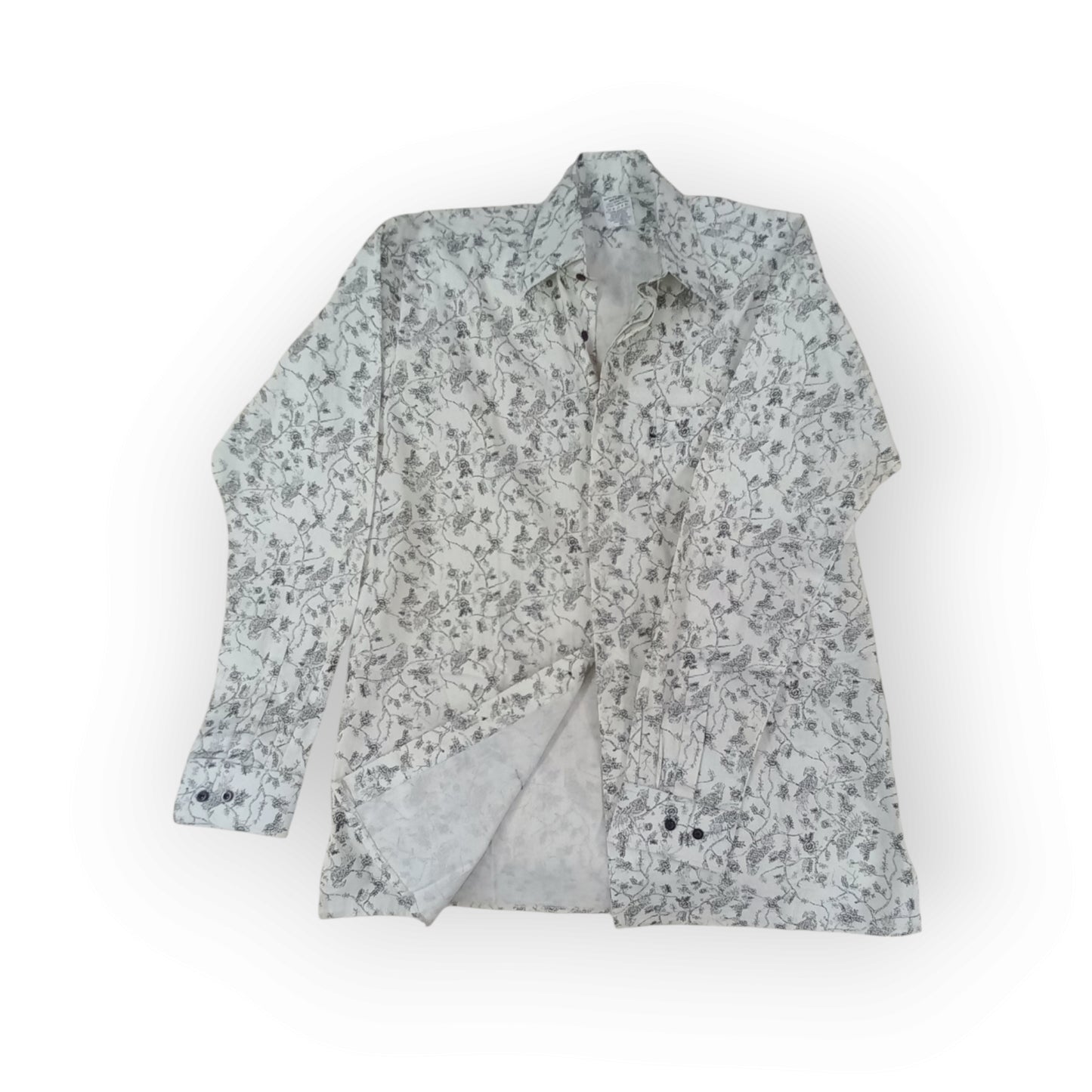  Rivatex long-sleeve shirt with a white background and intricate dark grey abstract vine pattern, made in Kenya.