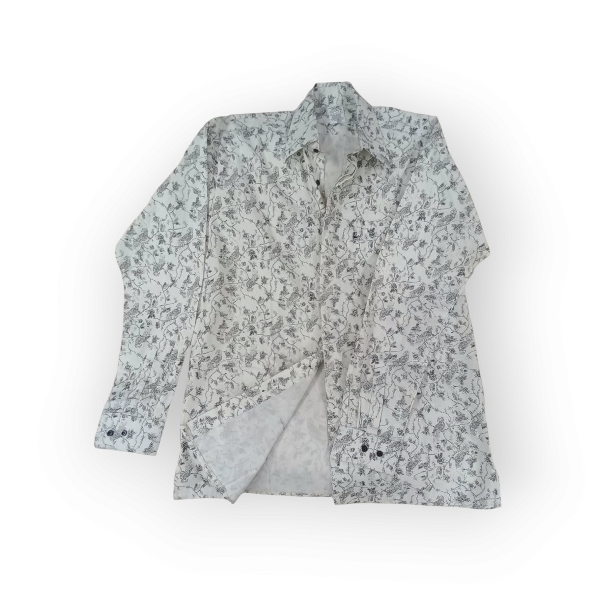  Rivatex long-sleeve shirt with a white background and intricate dark grey abstract vine pattern, made in Kenya.
