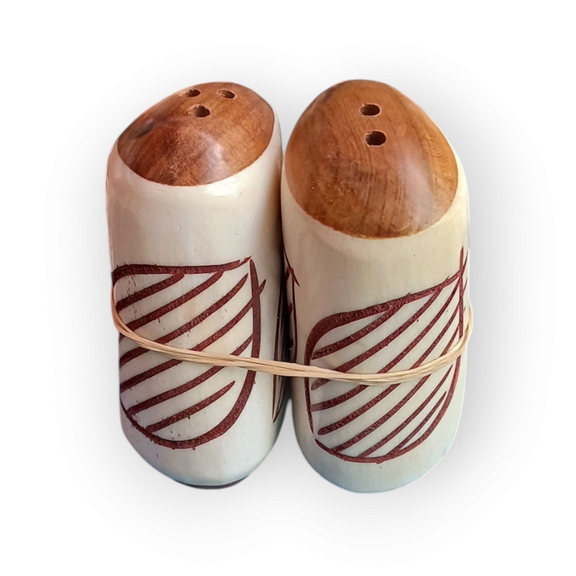 a pair of salt and pepper shakers  with a geometric patter. made of camel bone with a wooden base. 