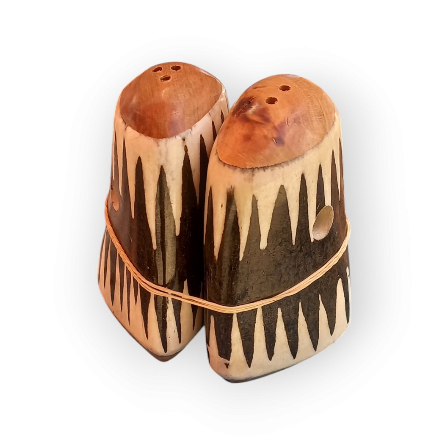 a pair of black and white salt and pepper shakers made of camel bone. handmade in Kenya 