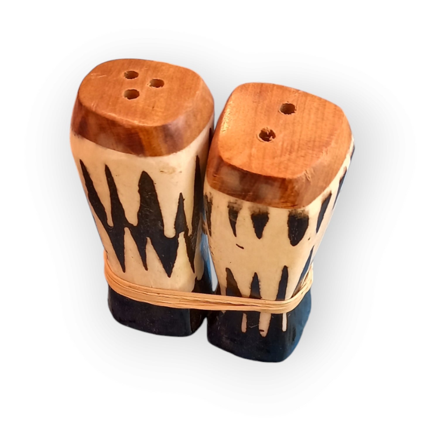 a pair of black and white cow bone salt & pepper shakers. Handmade in Kenya 