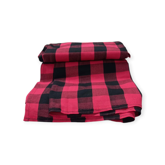 A red and black check pattern Maasai Shuka, a traditional Kenyan blanket from Rivatex.
