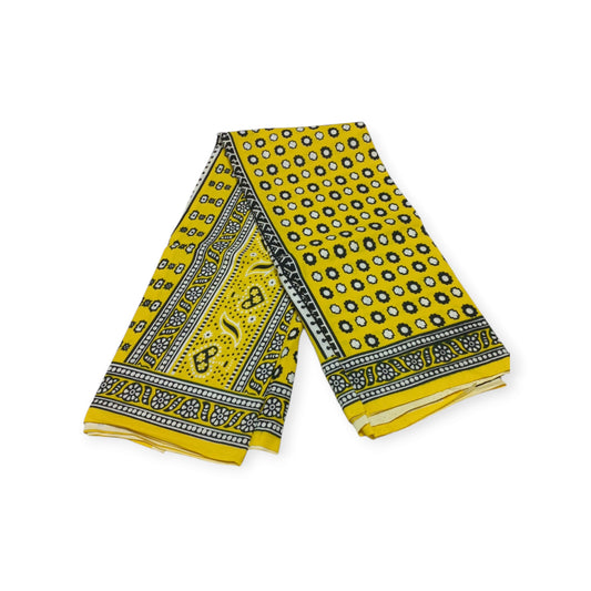 Pair of yellow cotton lesos from Rivatex, featuring a black and white geometric pattern.
