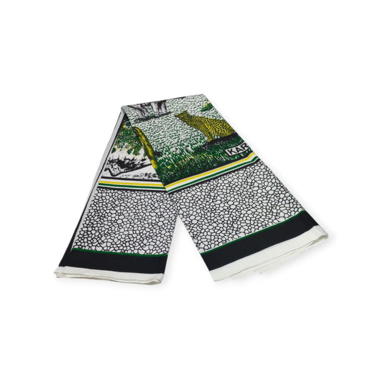 Pair of white cotton lesos from Rivatex, featuring images of lions, elephants, and other African animals, with the message 'Tulinde Mbuga Zetu' (Let's Protect Our Wildlife).
