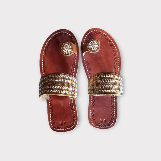 a pair of toe-ring leather Maasai sandals with multiple beads on the straps. Handmade in Kenya 