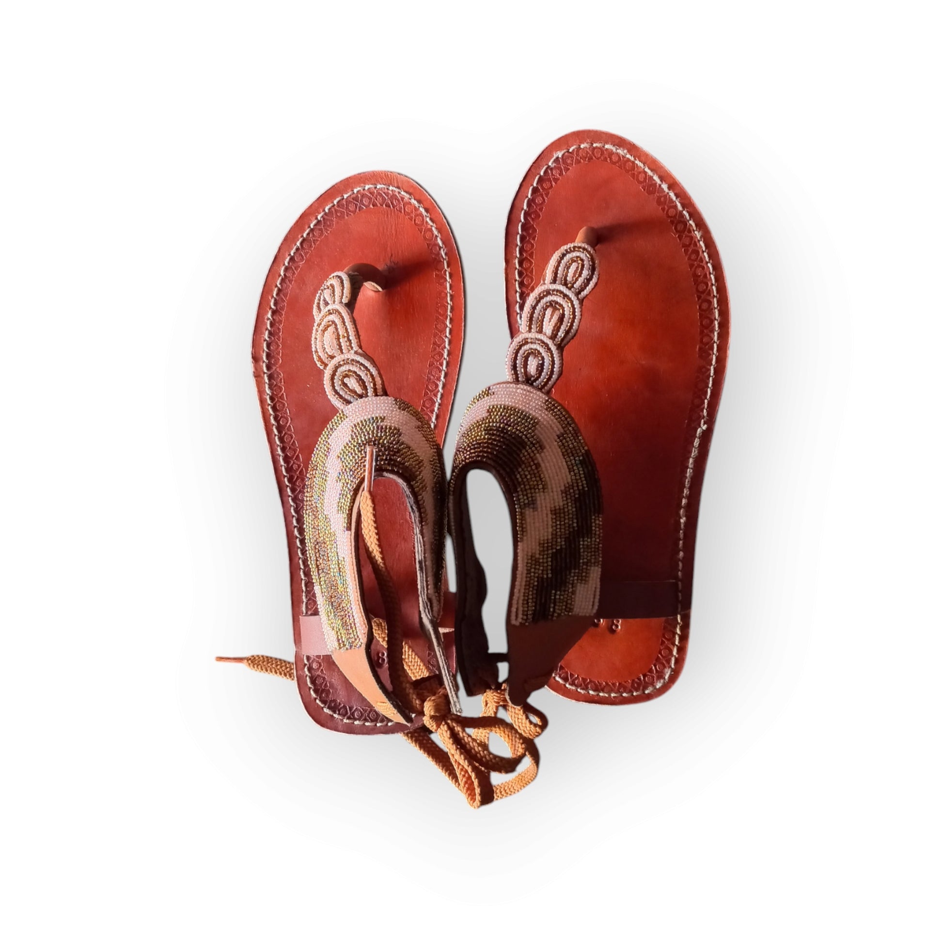 Handmade Maasai sandals with colorful beading and leather straps, made in Kenya.

