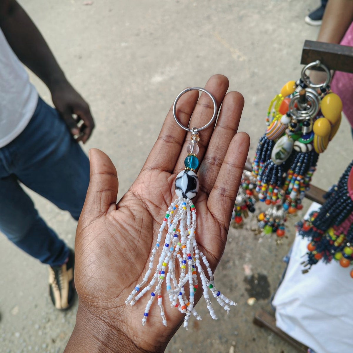 Nualocal handcrafted beaded tassel keychain with white glass seed beads and a focal black and white patterned bead