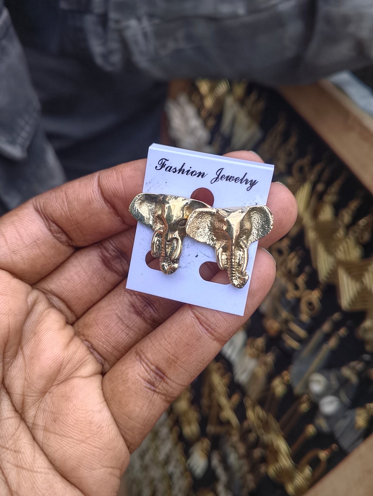 Handcrafted cast brass elephant head stud earrings with textured ears and trunk, artisan made in Kibera Nairobi Kenya