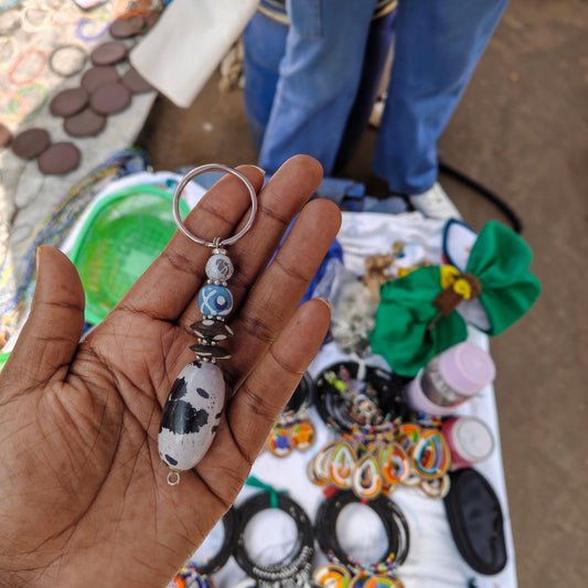 Nualocal handcrafted key holder with a black and white ceramic pendant, patterned beads, and silver-tone split ring.