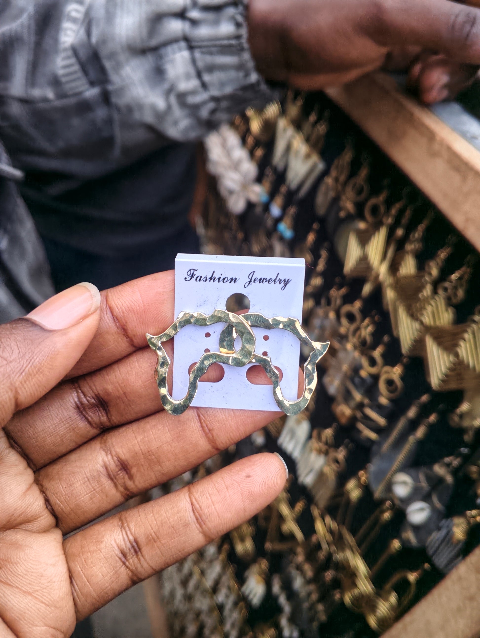 Handcrafted golden Africa map outline brass stud earrings with hammered texture, artisan made in Kibera Nairobi Kenya