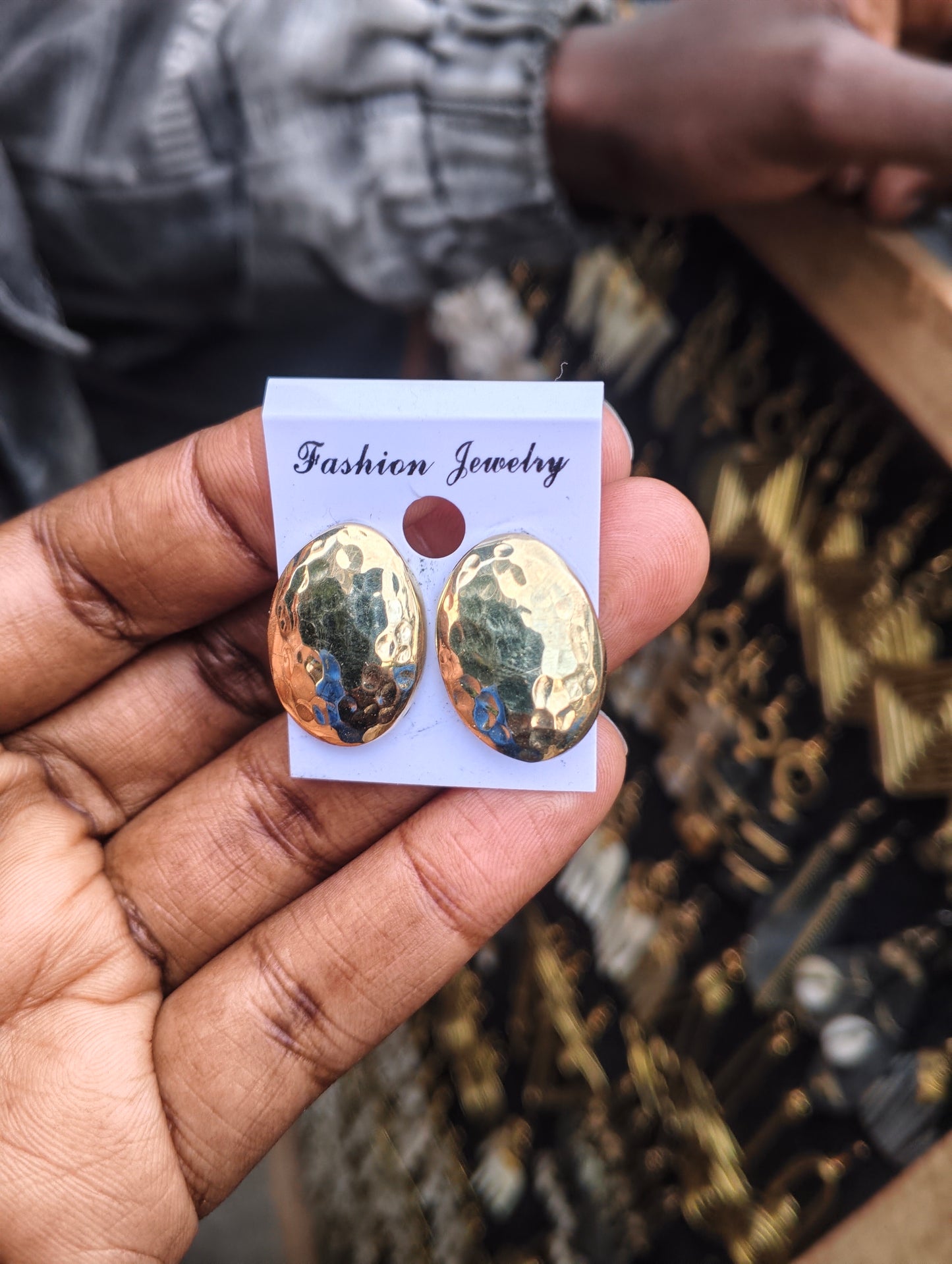 Handcrafted golden oval brass stud earrings with hammered texture, artisan made in Kibera Nairobi Kenya