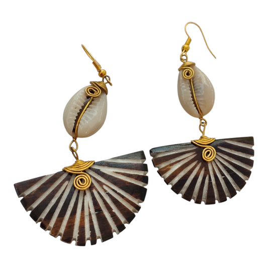 NuaLocal handcrafted dark brown and cream batik sunburst fan bone drop earrings with wire-wrapped natural cowrie shells and brass coils, made in Kibera, Nairobi, Kenya.