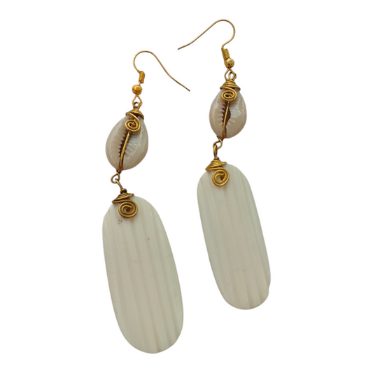 NuaLocal handcrafted off-white upcycled bone vertically fluted oval drop earrings with wire-wrapped brass coils and natural cowrie shells, made in Kibera, Nairobi, Kenya.
