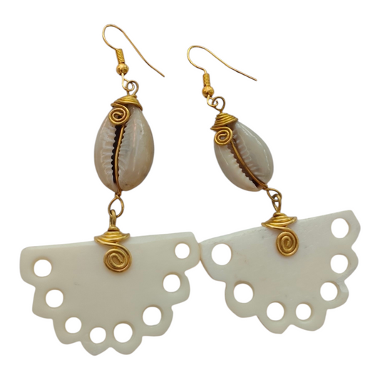NuaLocal handcrafted off-white upcycled bone half-moon fan drop earrings with scalloped cutout edges, wire-wrapped brass coils, and natural cowrie shells, made in Kibera, Nairobi, Kenya.