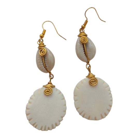 NuaLocal handcrafted natural off-white upcycled bone circular disc drop earrings with serrated notched edges, wire-wrapped brass coils, and natural cowrie shells, made in Kibera, Nairobi, Kenya.