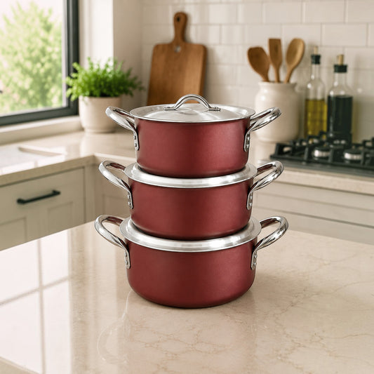 Nualocal Kaluworks 3-piece maroon non-stick aluminium sufuria set with stainless steel handles on a kitchen counter