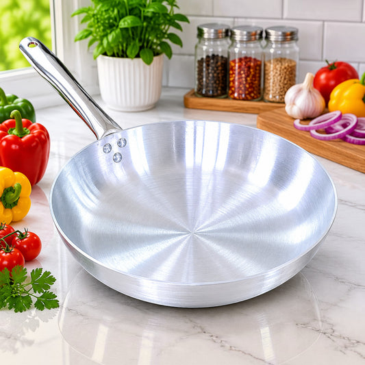 Nualocal Pardini 700 Series polished aluminium omelette pan with a triple-riveted handle on a kitchen counter.