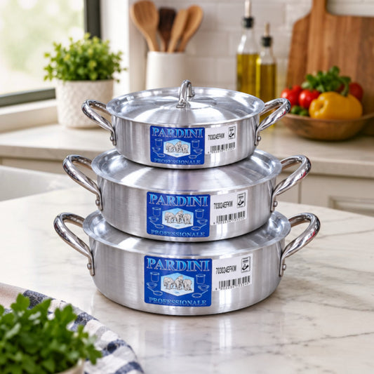 Nualocal set of 3 Kaluworks Pardini professional shallow aluminium casserole pots with lids stacked on a kitchen counter