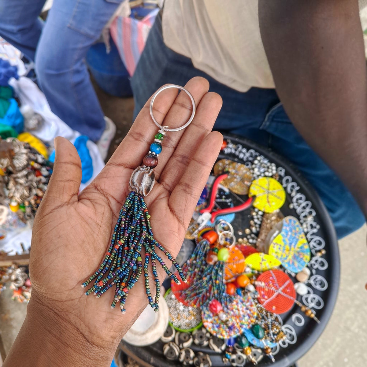 Nualocal handcrafted rainbow beaded tassel keychain with iridescent glass seed beads and a metal split ring