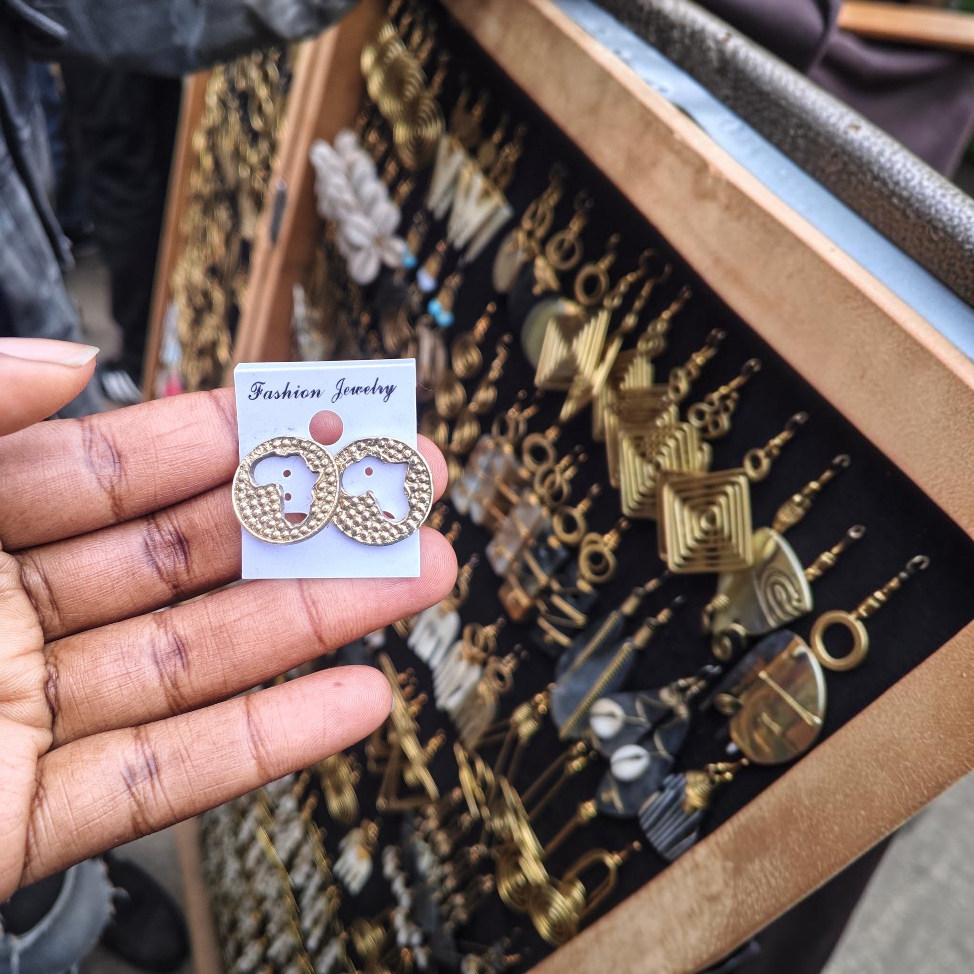 Nualocal circular brass stud earrings featuring a cutout of the African continent with a textured finish